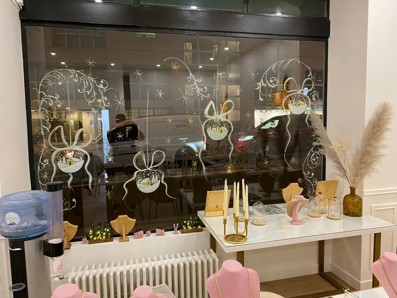 Jewellery window decorated with painted Christmas baubles